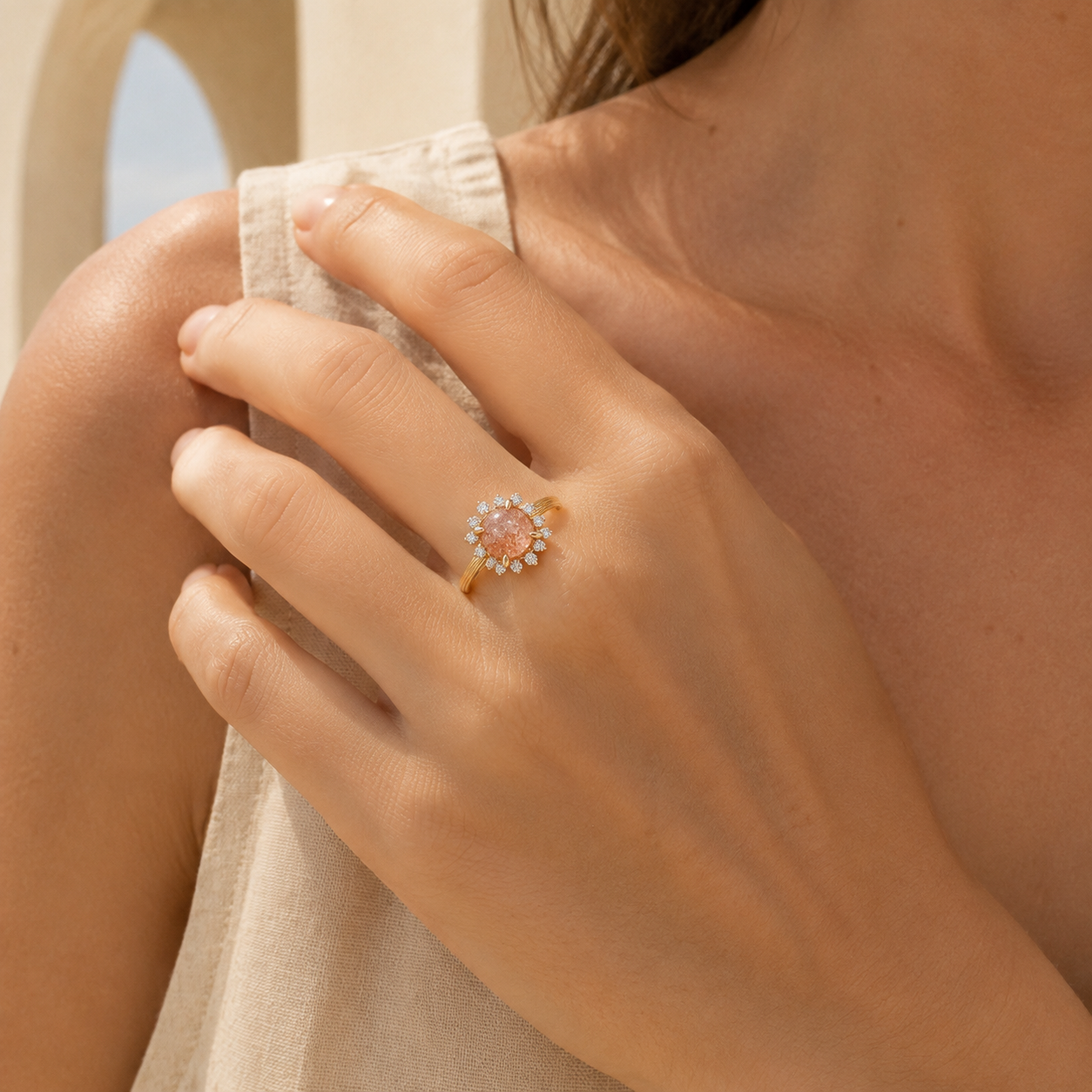 Farther lifestyle view of the Marisol sunstone halo ring worn in a warm ivory setting