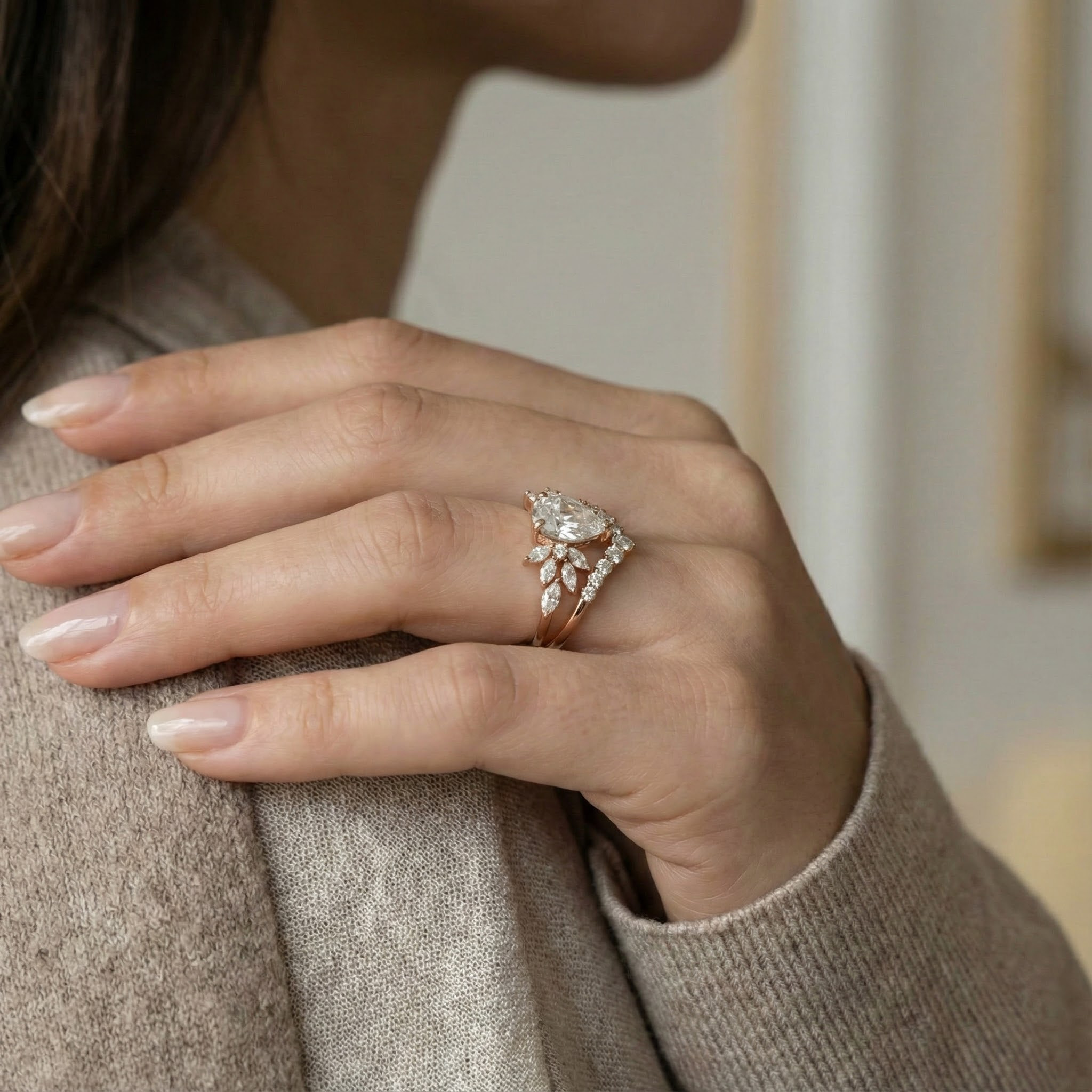 Exquisite pear moissanite ring set adorned with luxurious butterfly detail