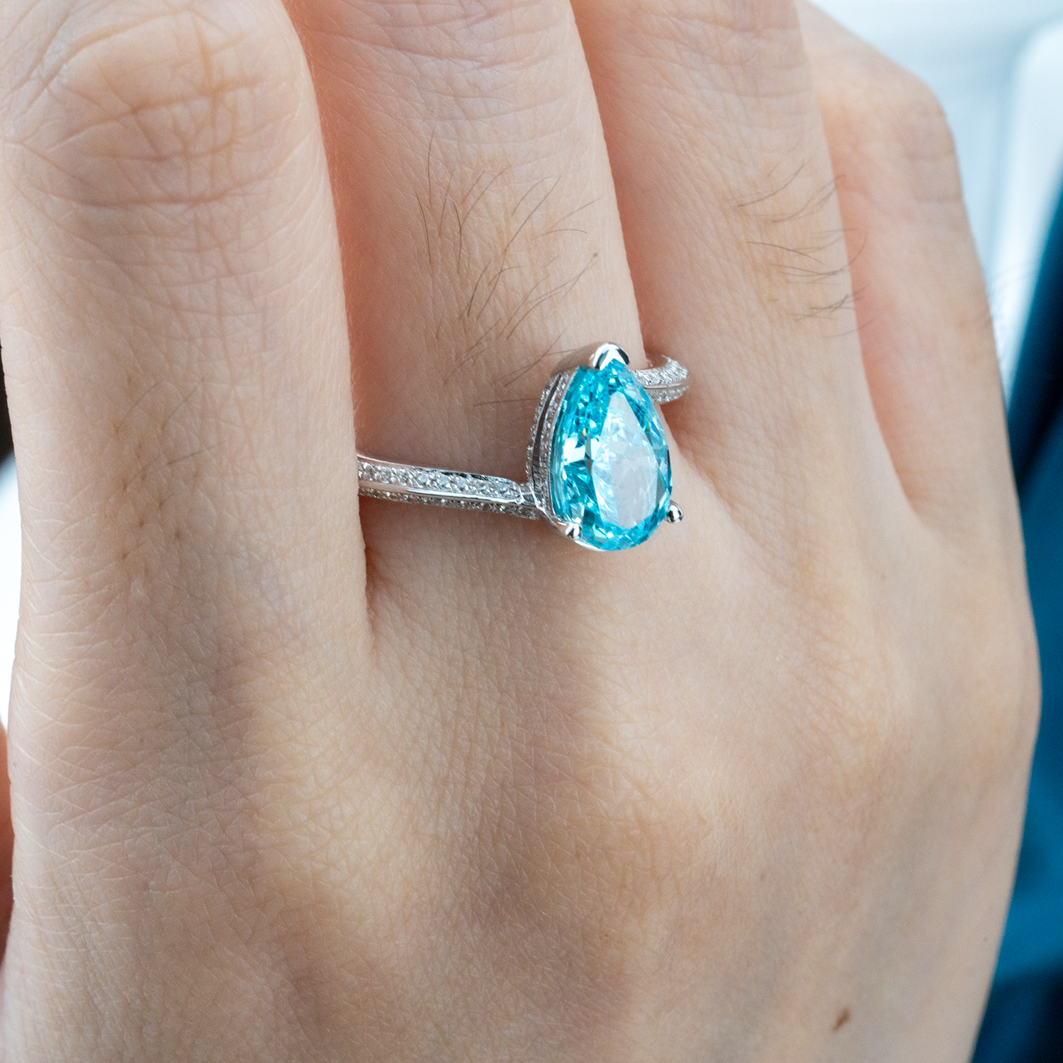 Elegant streamlined blue zircon ring featuring shimmering moissanite stones