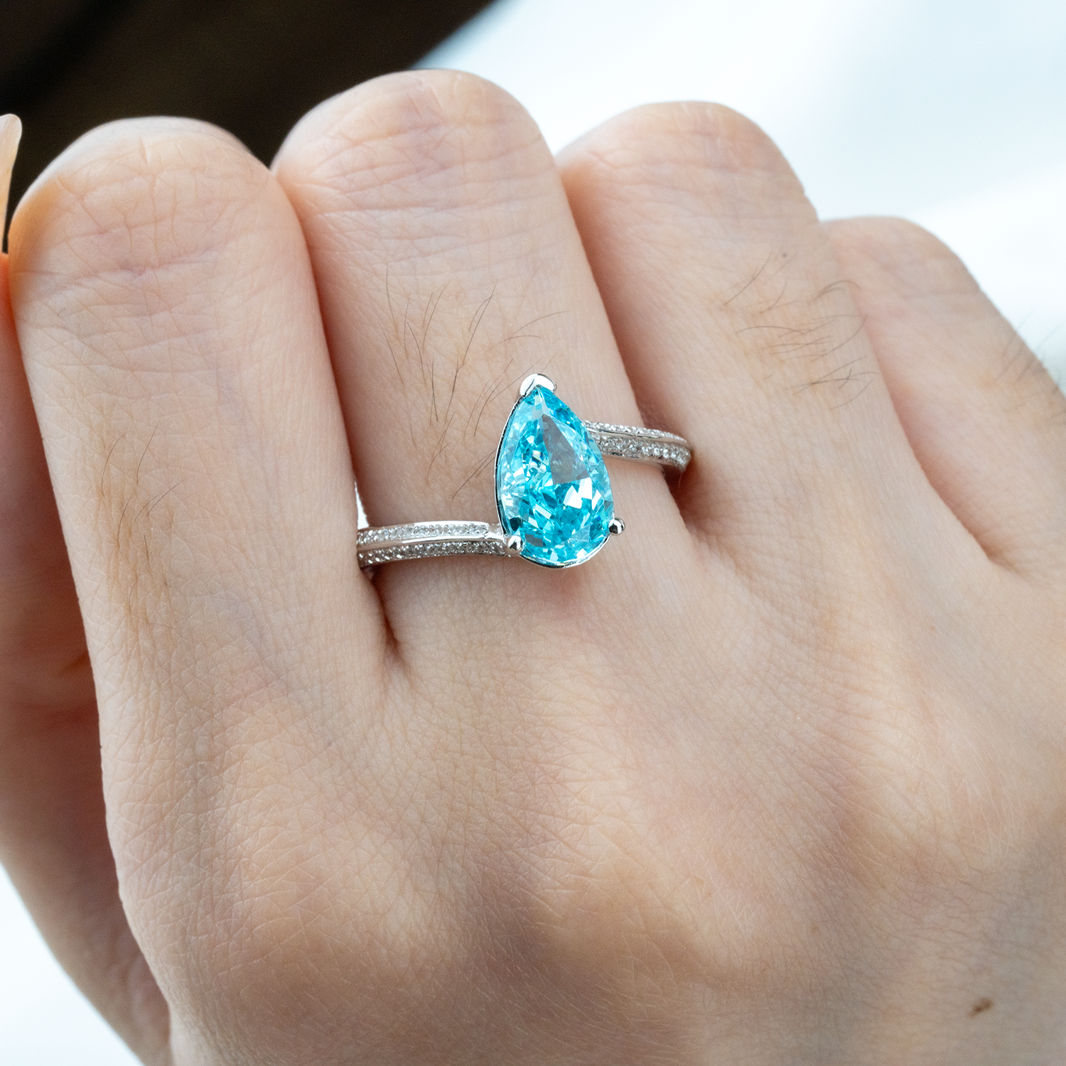 Elegant streamlined blue zircon ring featuring shimmering moissanite stones