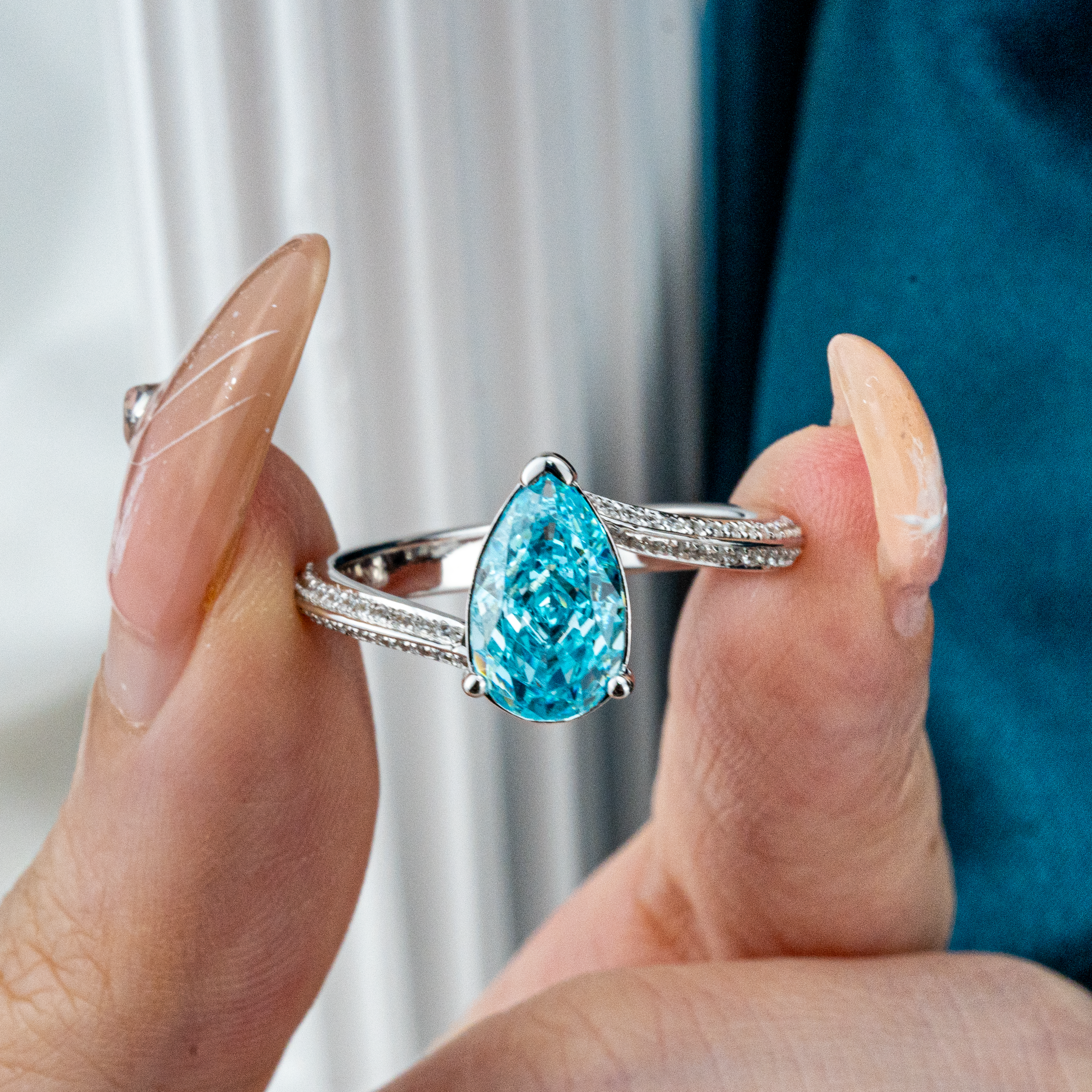 Elegant streamlined blue zircon ring featuring shimmering moissanite stones