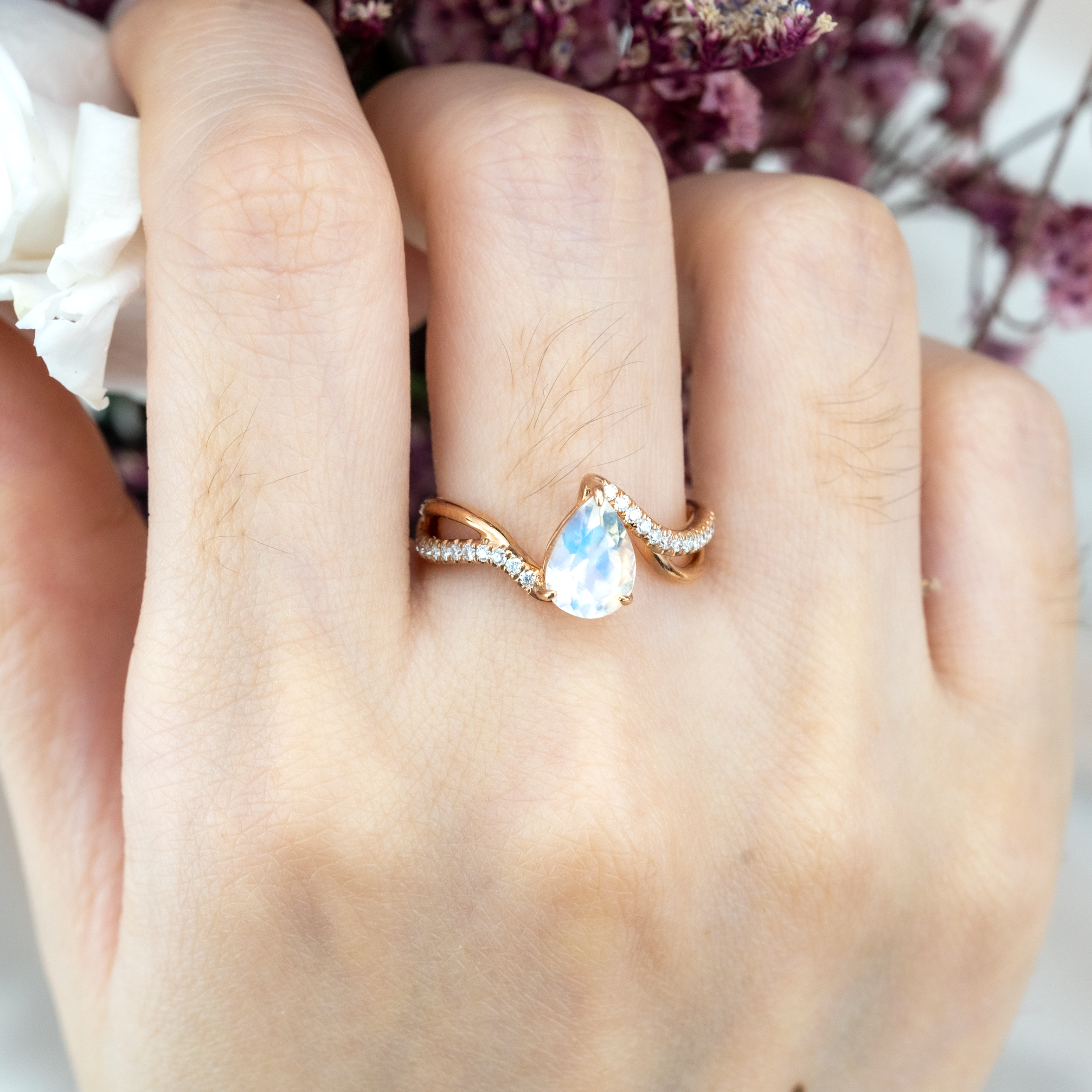 Luxurious moonstone engagement ring featuring pear cut stone
