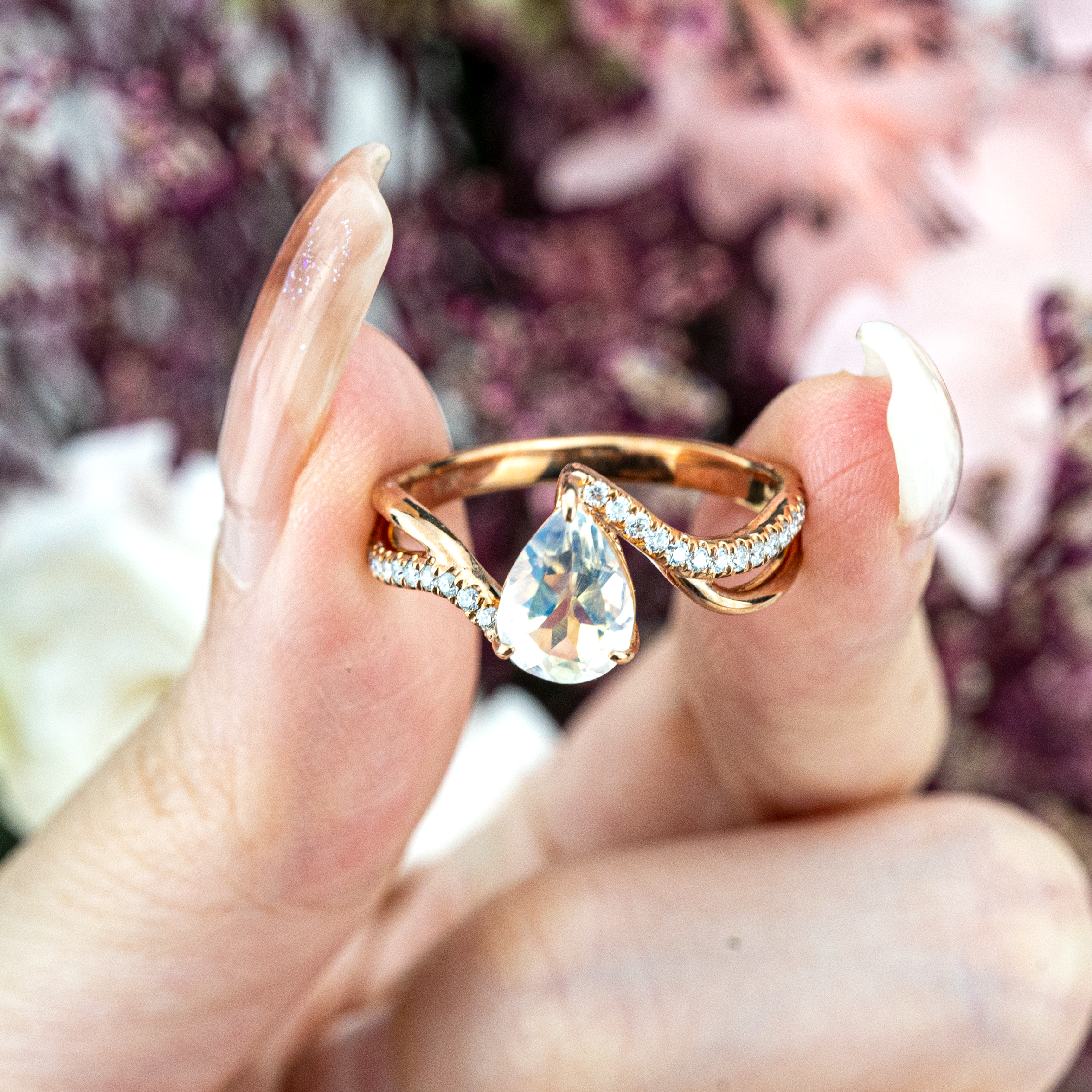 Luxurious moonstone engagement ring featuring pear cut stone