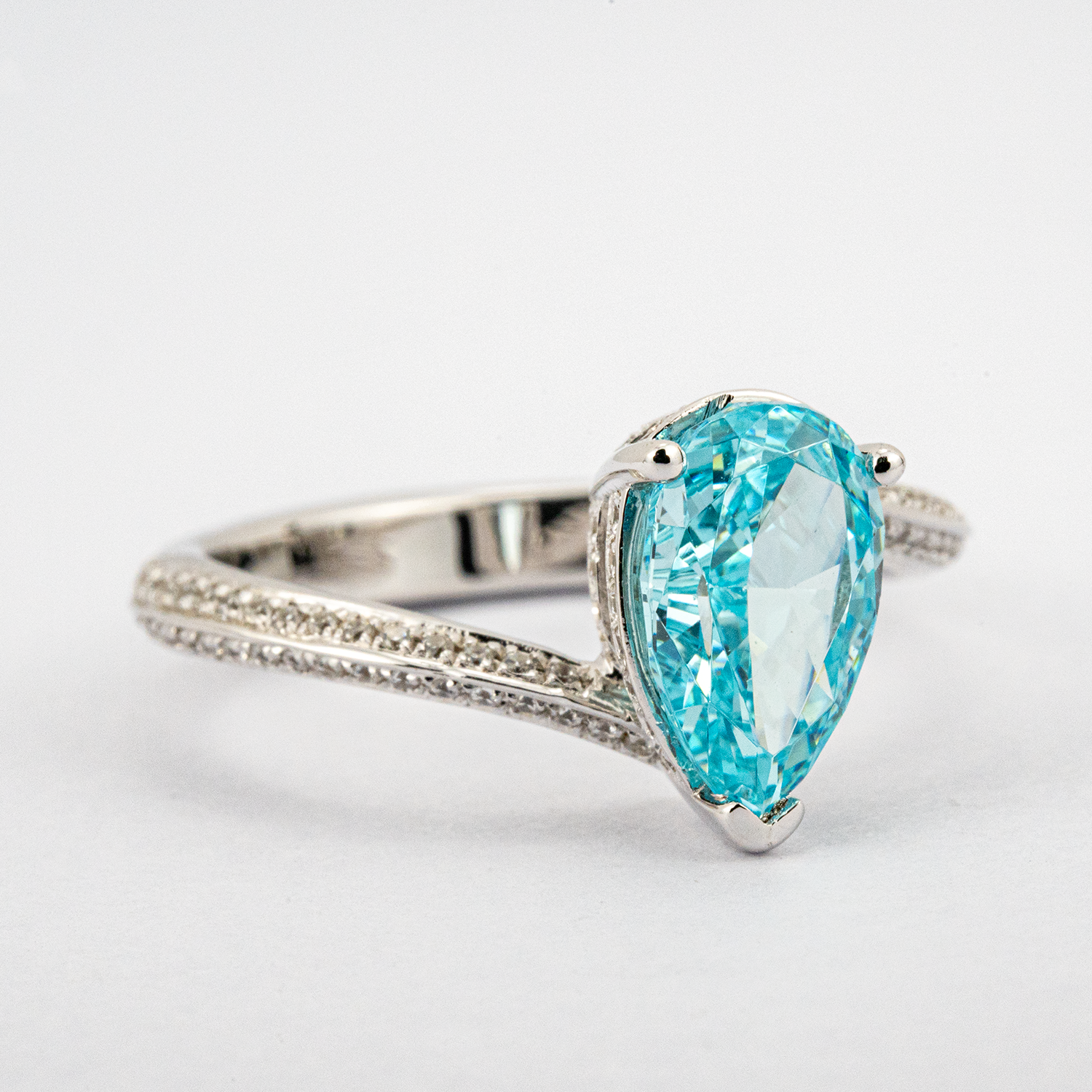 Elegant streamlined blue zircon ring featuring shimmering moissanite stones