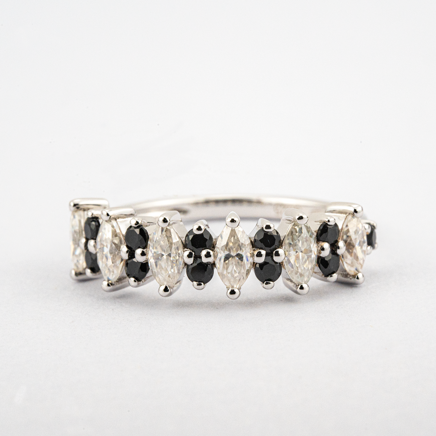 Luxurious marquise black onyx band featuring shimmering moissanite gemstone.