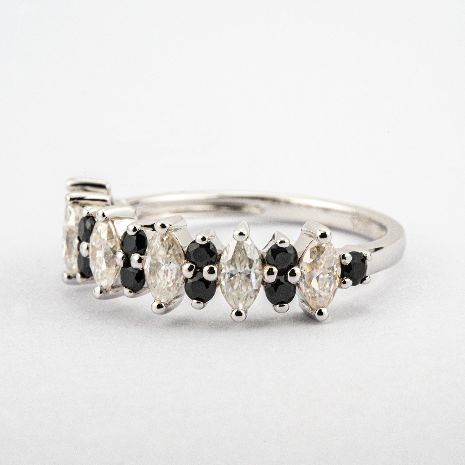 Luxurious marquise black onyx band featuring shimmering moissanite gemstone.