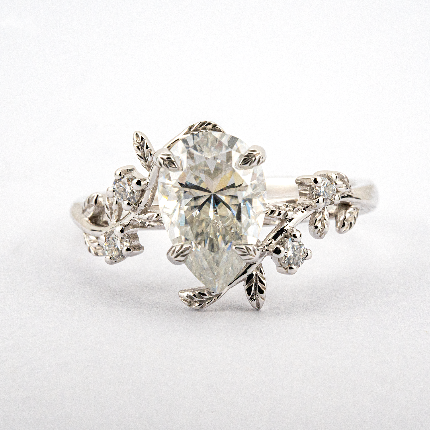 White Gold Pear Moissanite Ring crafted in nature inspired setting for unique and stylish appeal