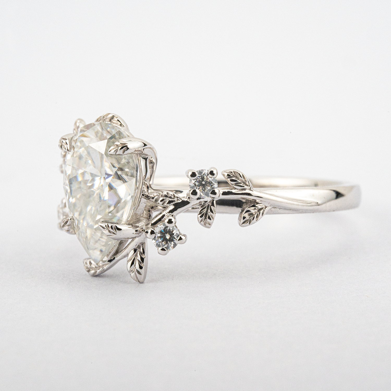 White Gold Pear Moissanite Ring crafted in nature inspired setting for unique and stylish appeal