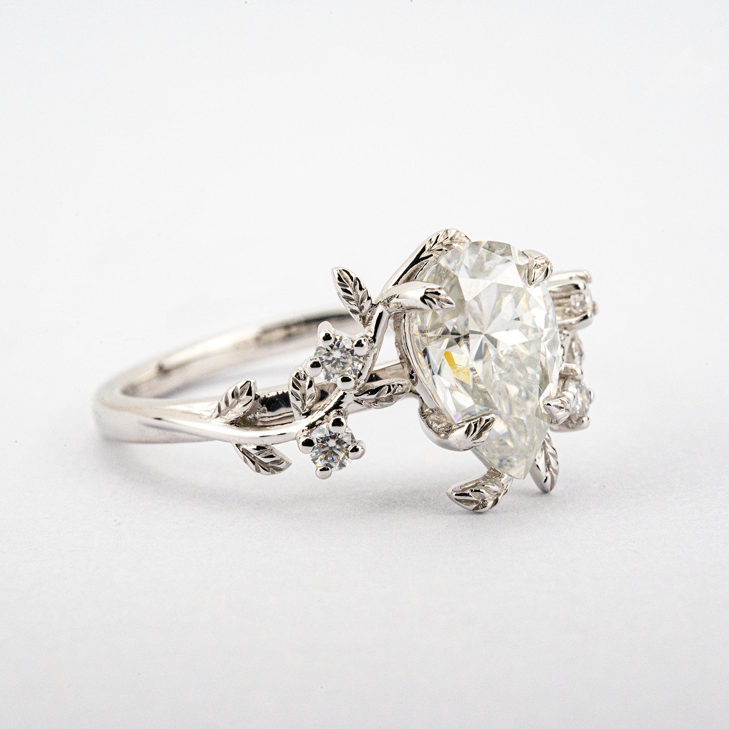 White Gold Pear Moissanite Ring crafted in nature inspired setting for unique and stylish appeal