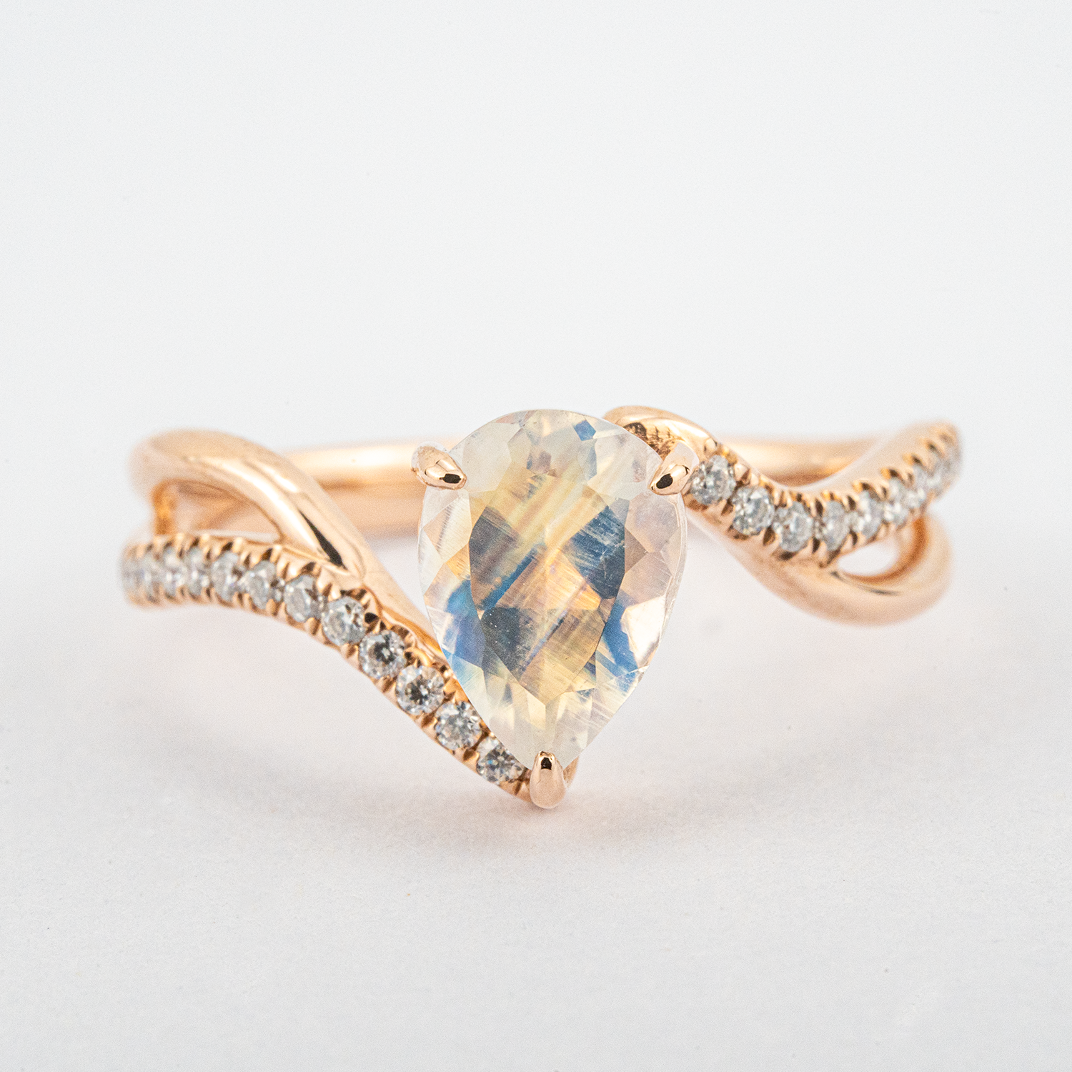 Luxurious moonstone engagement ring featuring pear cut stone
