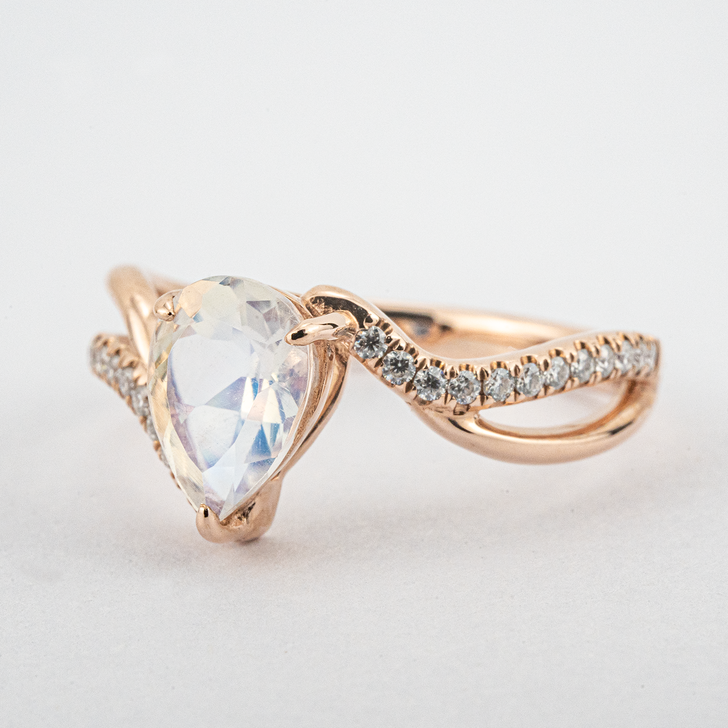 Luxurious moonstone engagement ring featuring pear cut stone