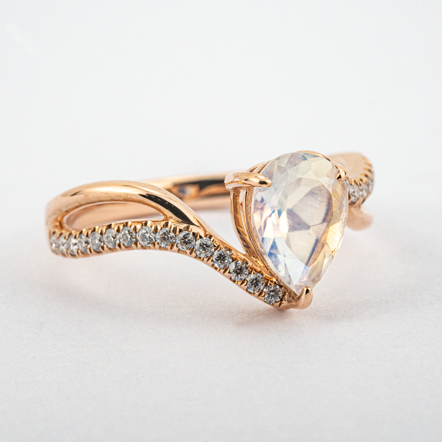 Luxurious moonstone engagement ring featuring pear cut stone