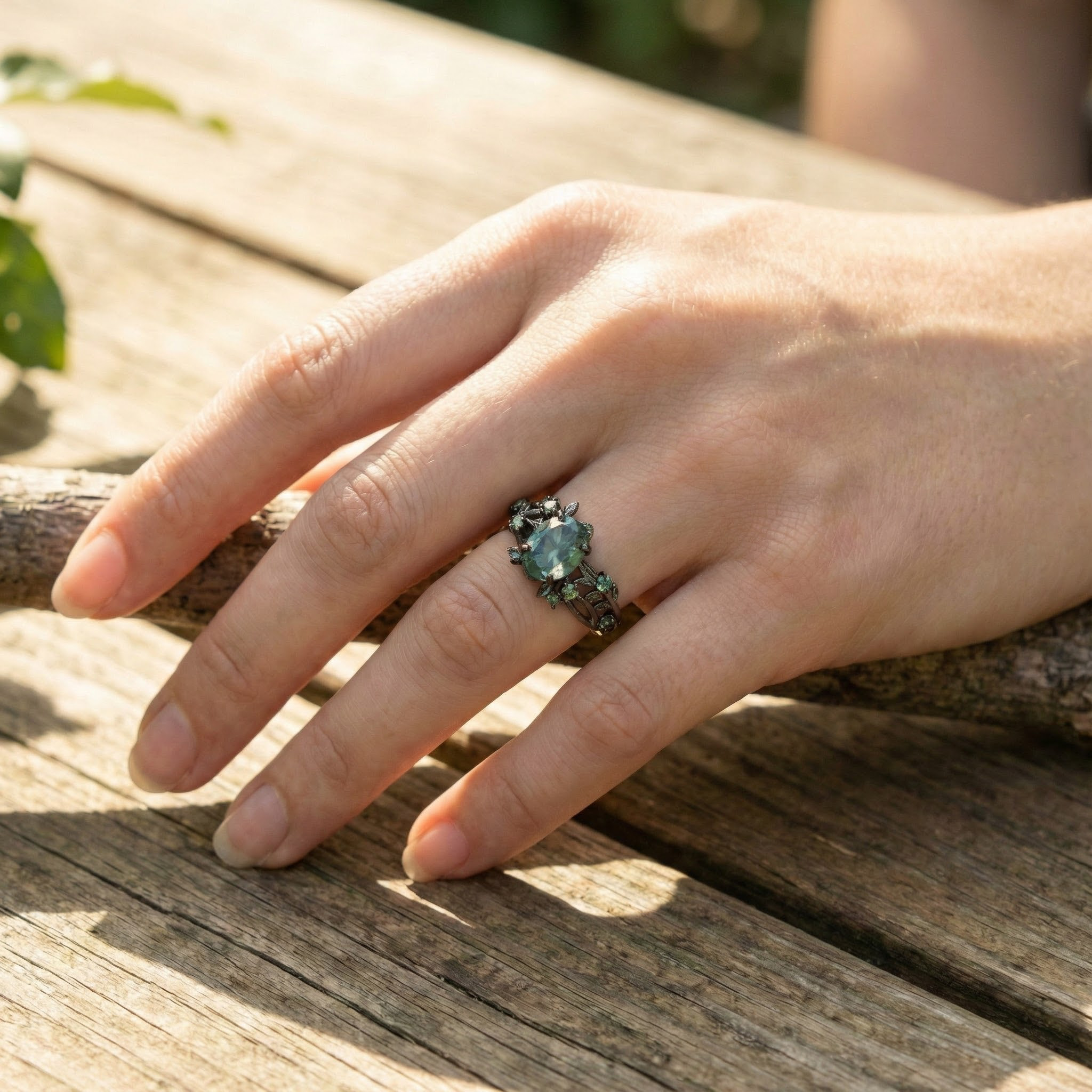 Angled view of Oval Moss Agate Ring in Black Gold