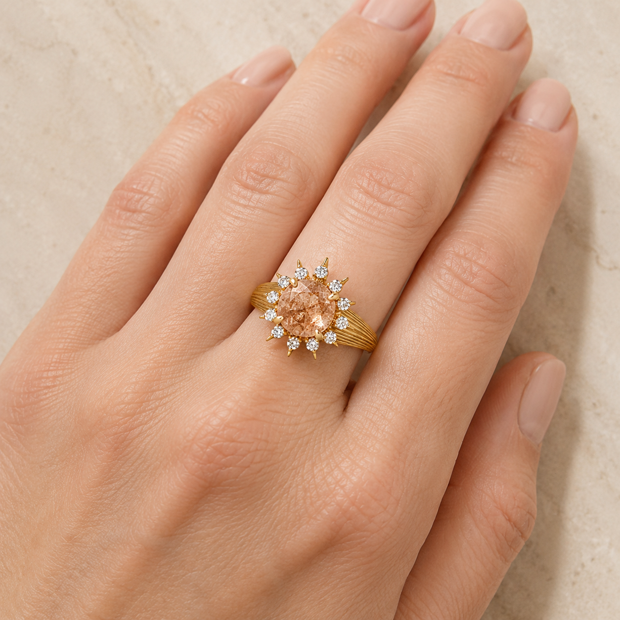 Solara faceted round sunstone and moissanite halo ring in yellow gold, left three-quarter view