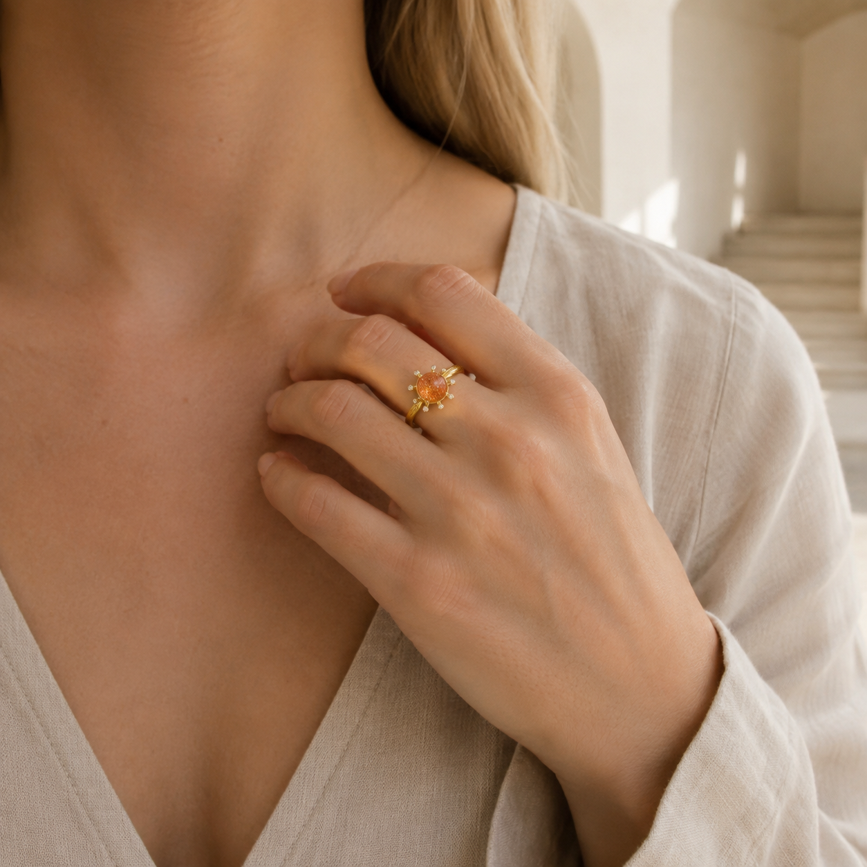 Farther model view of the Aurelia celestial sunstone ring worn with a neutral linen outfit