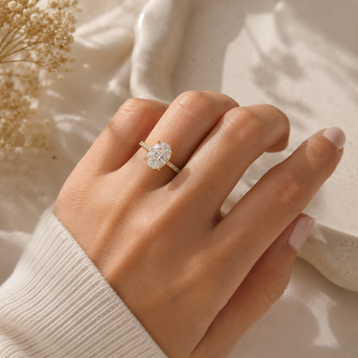 Oval lab-grown diamond hidden halo engagement ring in yellow gold with pavé diamond band