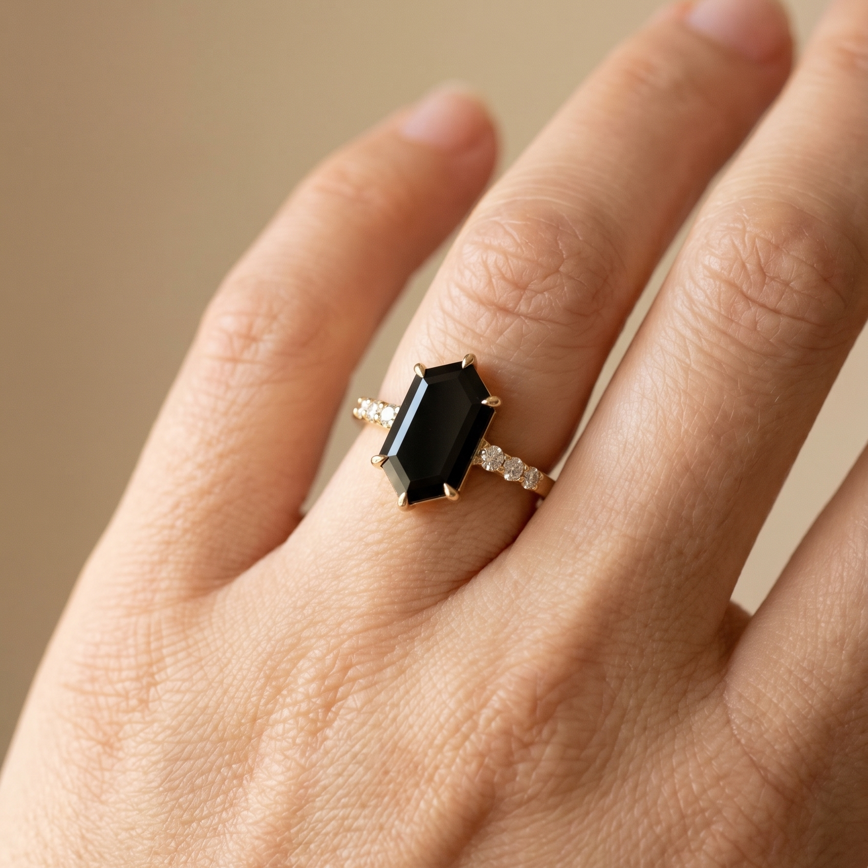 Hexagon black onyx engagement ring with gold band and diamond accent stones