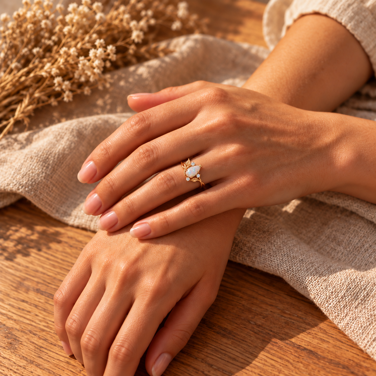 Nature-inspired opal ring with sculpted leaves and flowing gold vine details