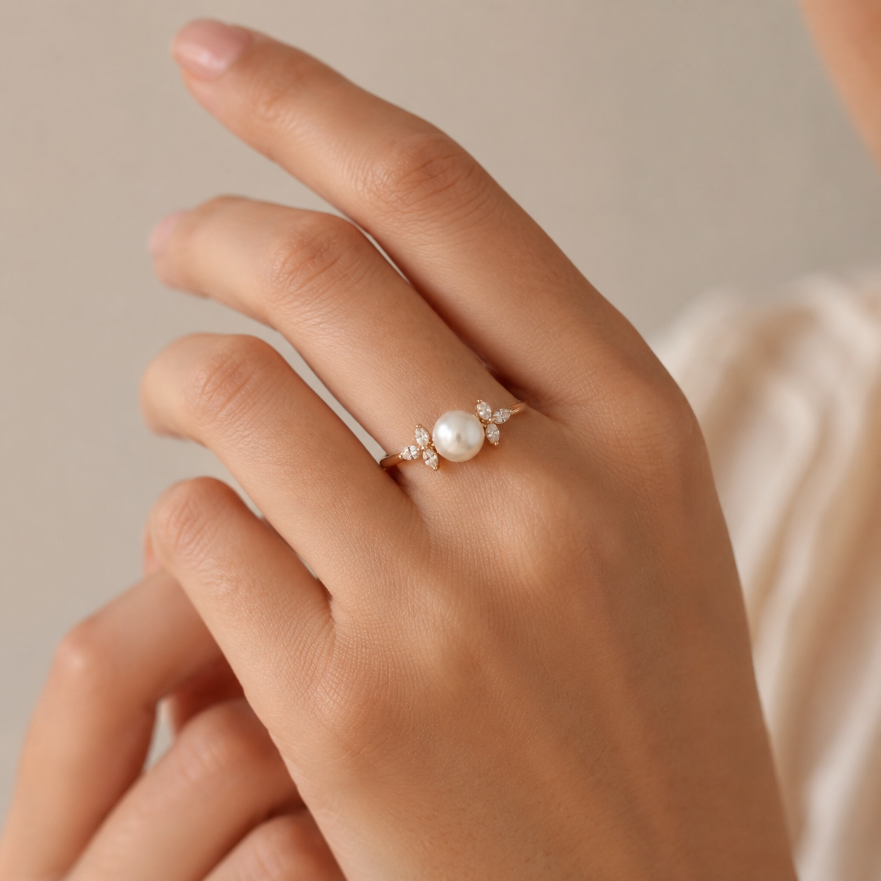 Hand model wearing Pearl Engagement Ring in Rose Gold